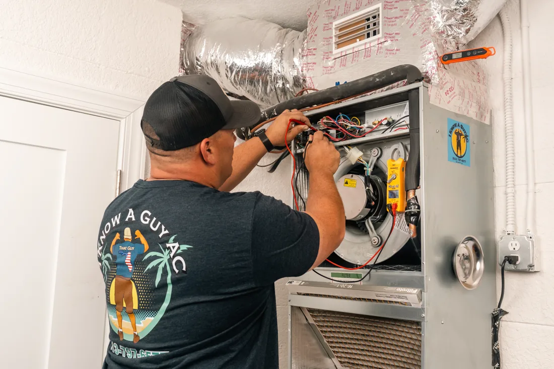Technician wiring a new system during an install