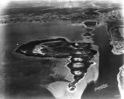 A 1925 aerial of low natural islands and open shallows in Tampa Bay before any dredging — the raw grass flats and bay bottom that would be turned into land.
